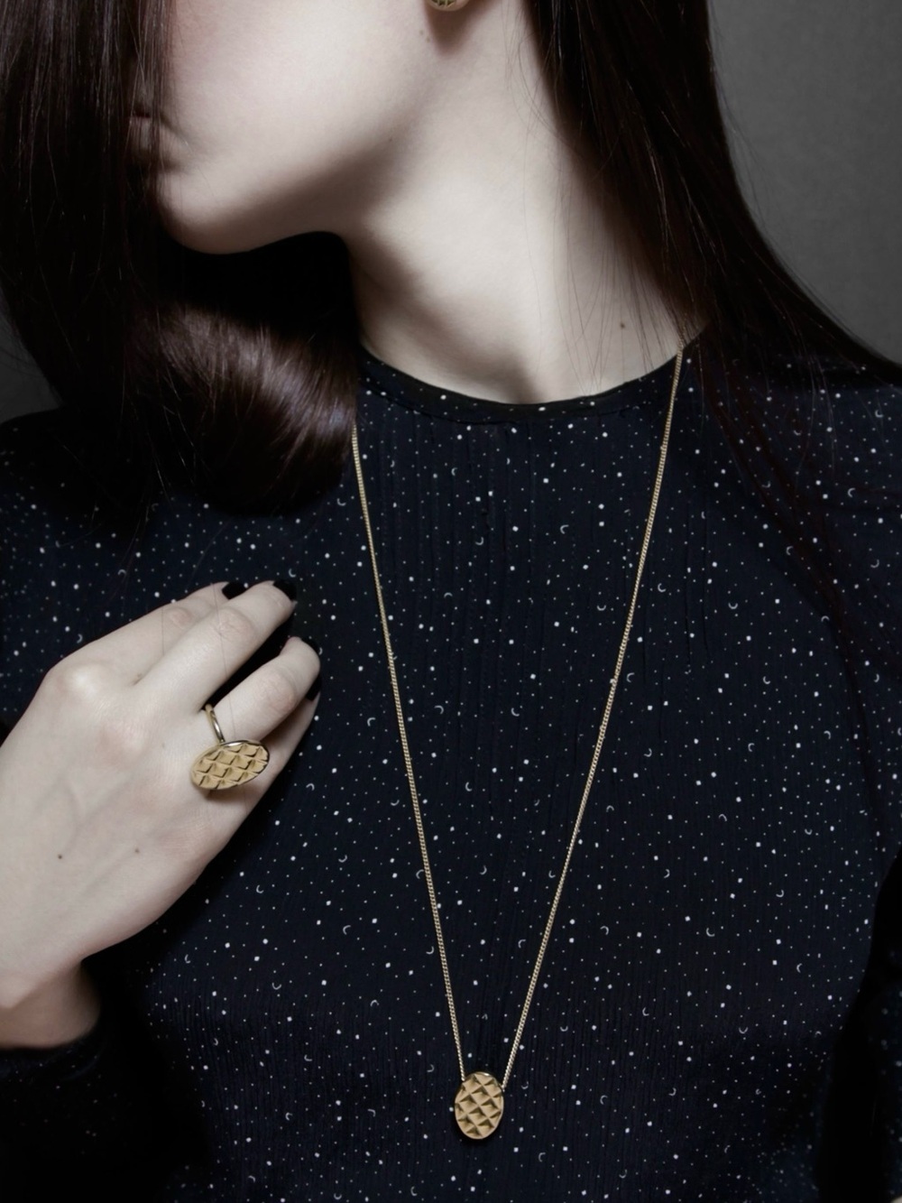 By AMT’s “Quilt” necklace in white brass